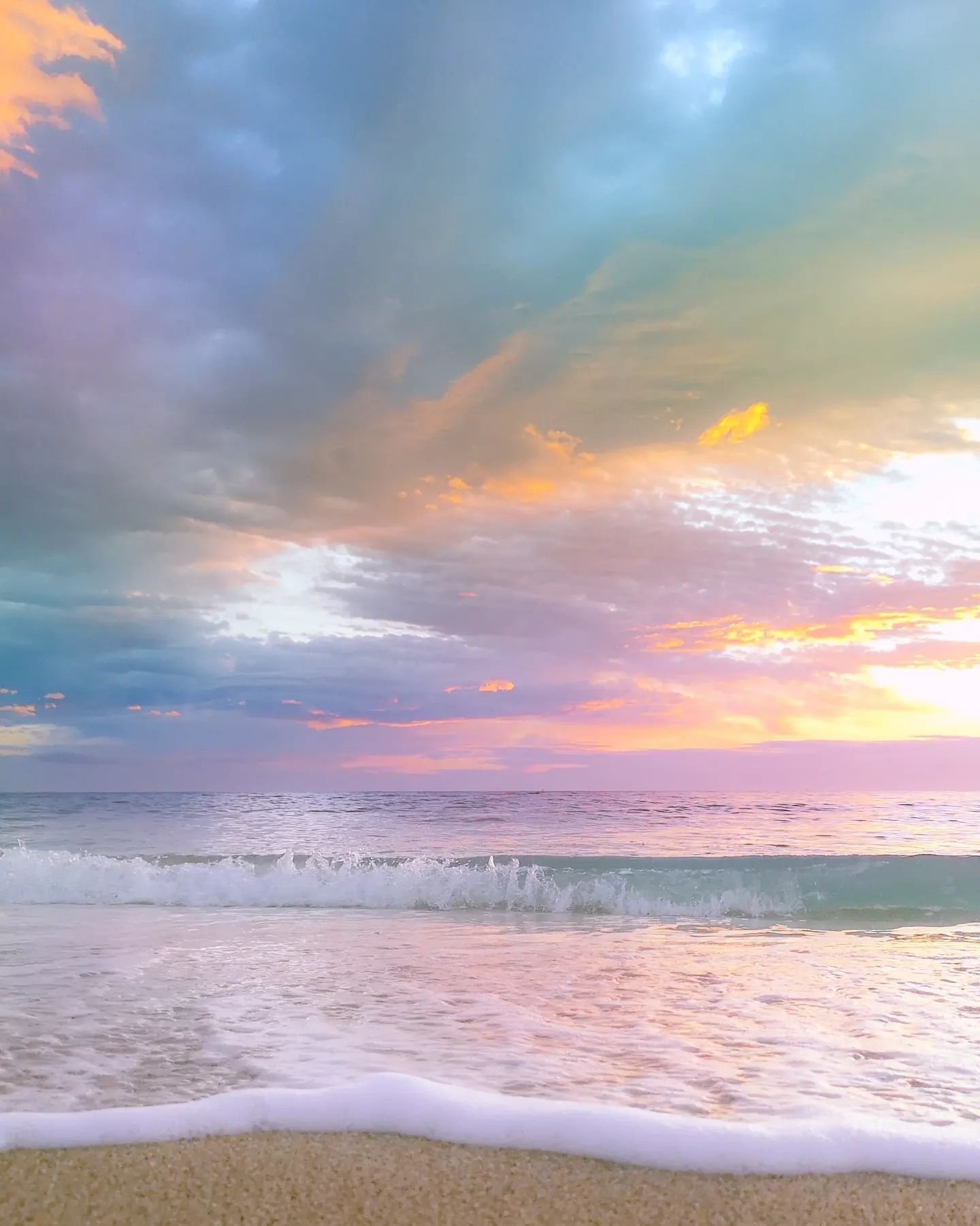 a photorealistic image of a serene beach at sunset with pastel colored …