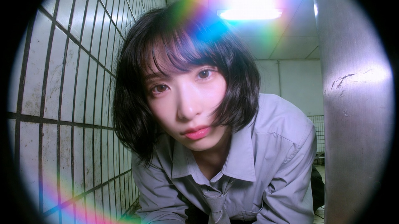 A stunning mid-20s Japanese or Korean woman wearing a light grey collar…
