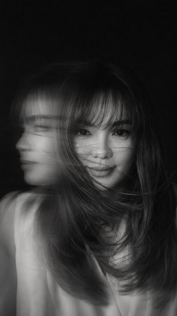 A hyper-realistic, cinematic black-and-white portrait of a woman caught…