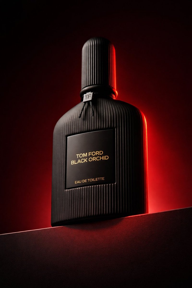 Low angle luxury product photography of a black ribbed glass perfume bo…