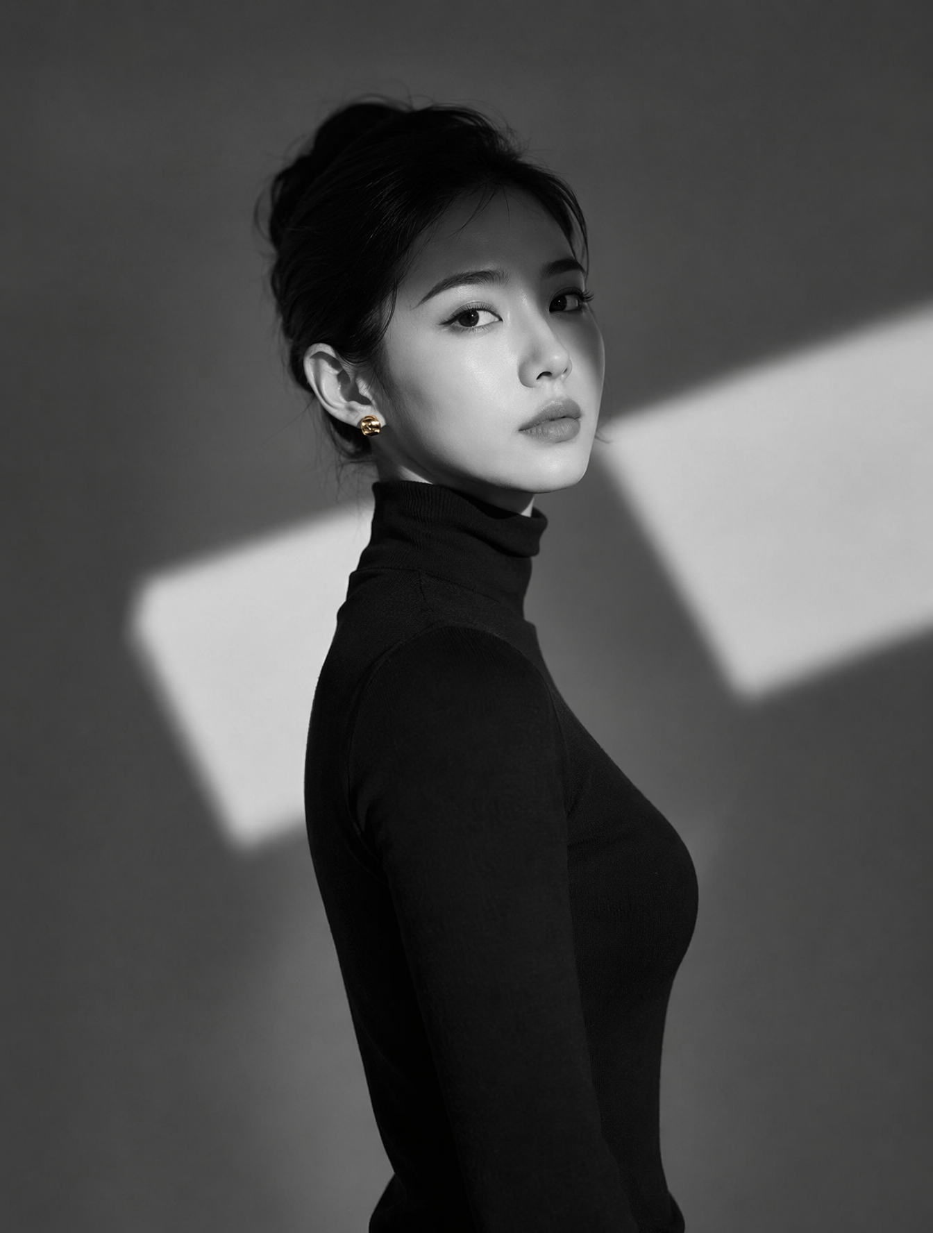 A high-resolution black and white portrait of a woman wearing a sharp b…