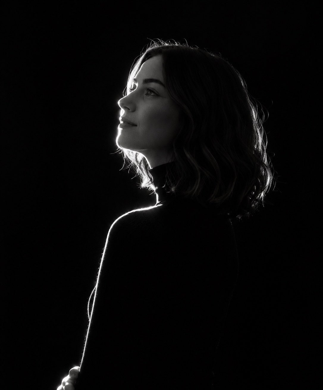 ​“A stark, high-contrast, black-and-white (monochromatic) side-profile …