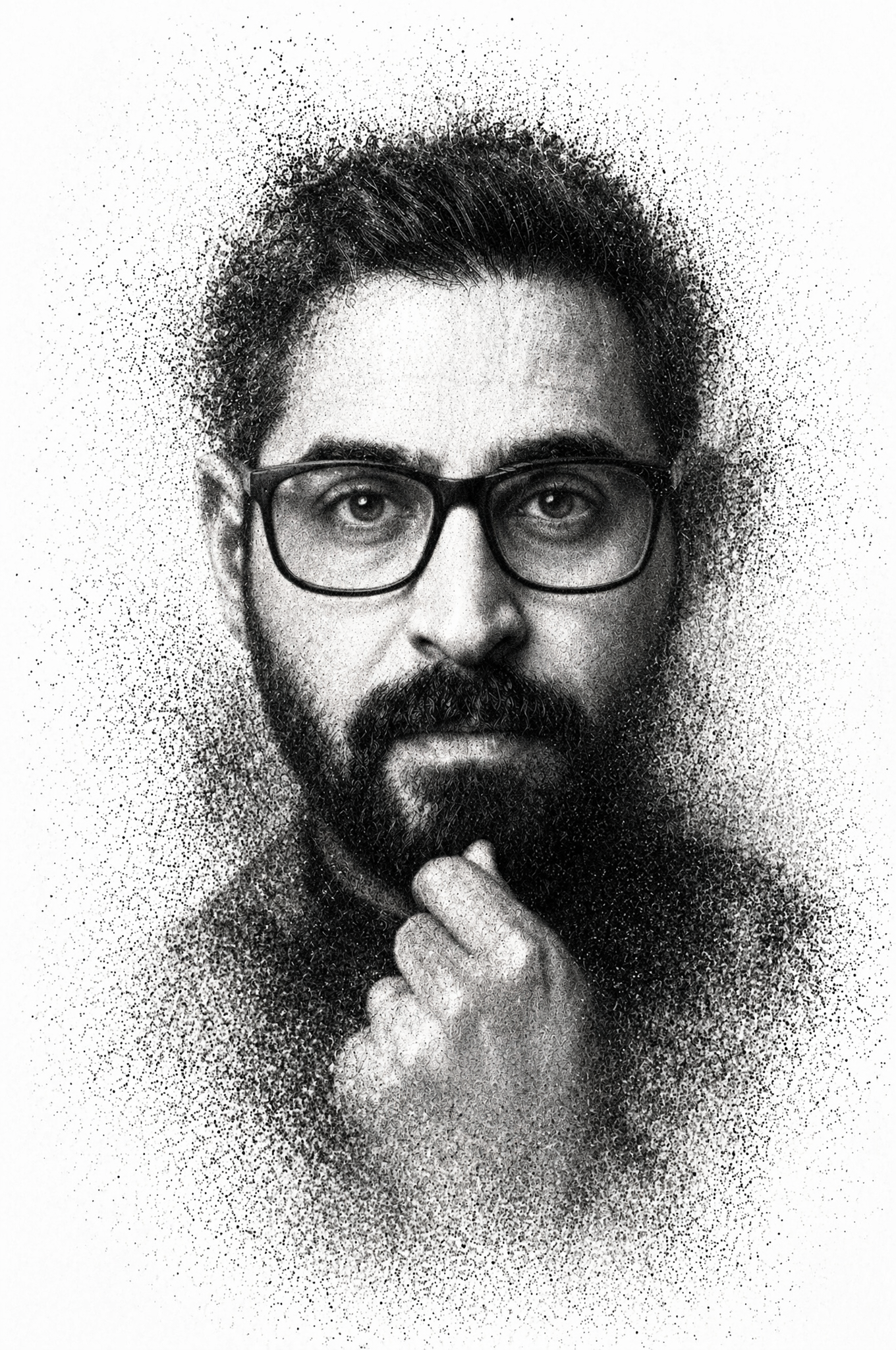 A high-contrast monochrome portrait depicts a man with a groomed beard …