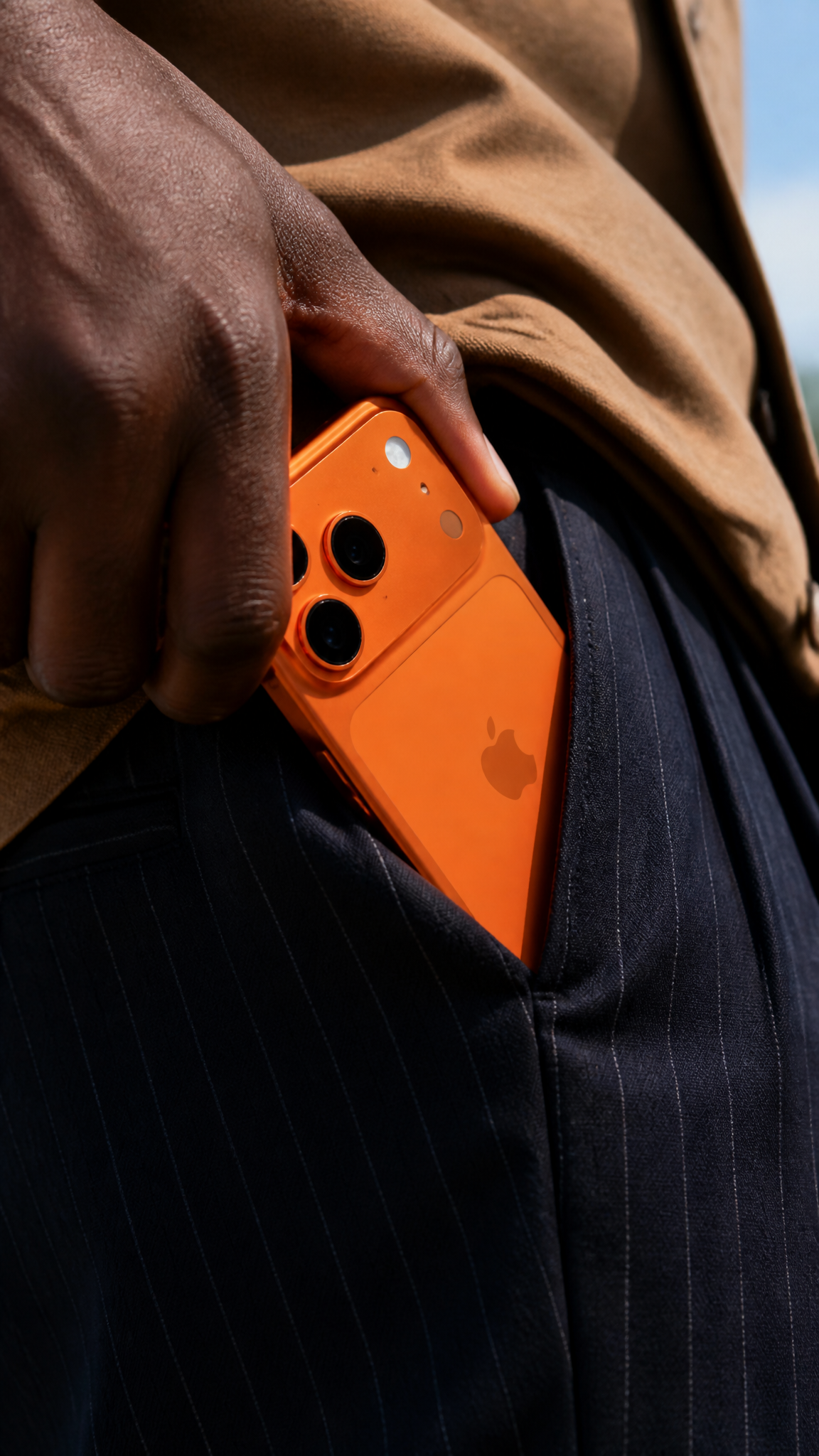 A close-up shot shows a person's dark-skinned hand, likely belonging to…