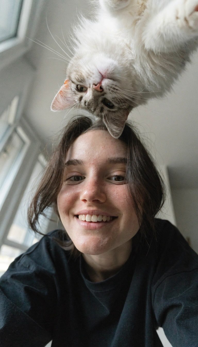 Create a realistic vertical smartphone selfie taken indoors from a very… 1
