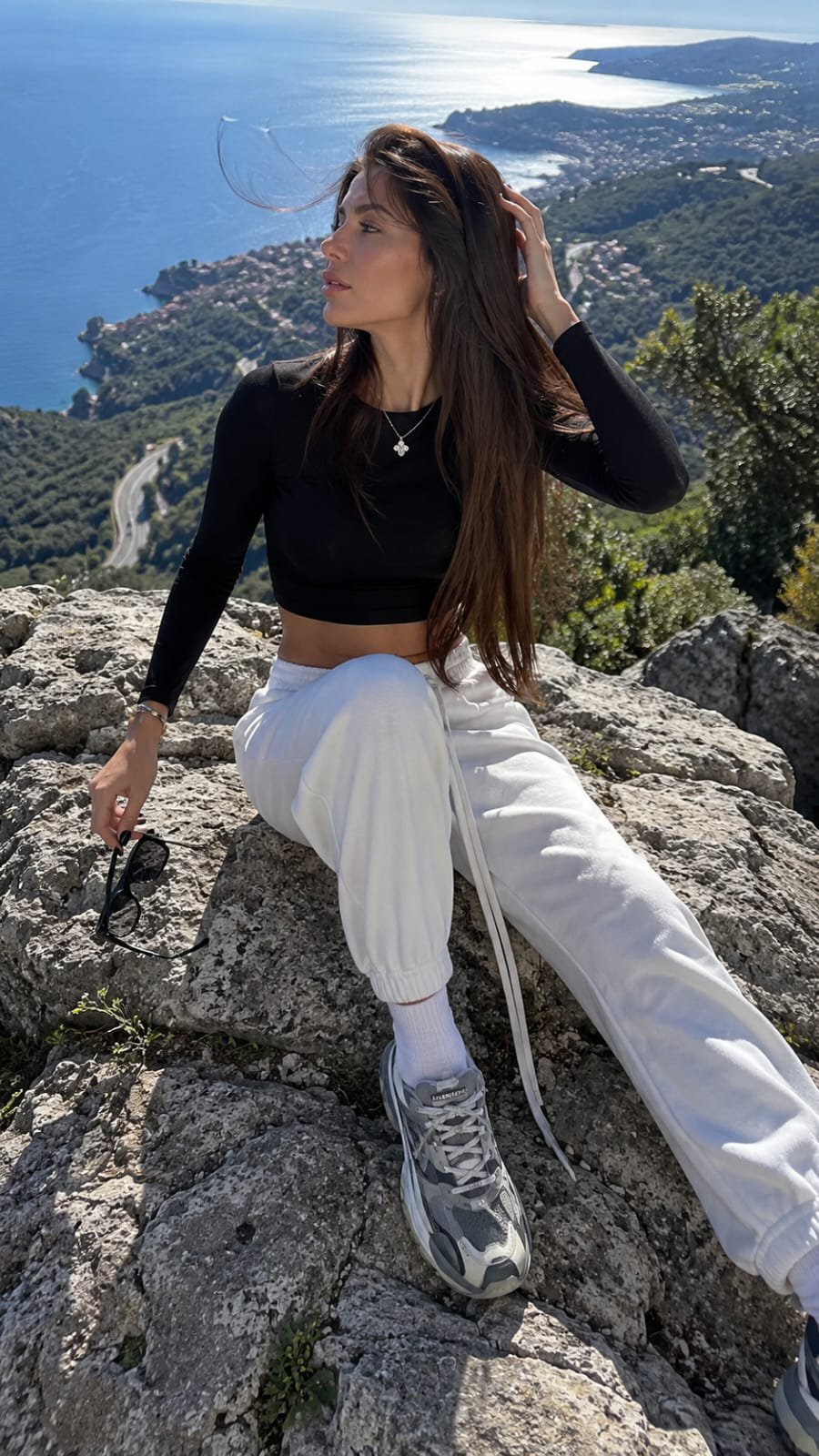 A candid luxury travel-fashion photograph with a natural, unstaged feel…