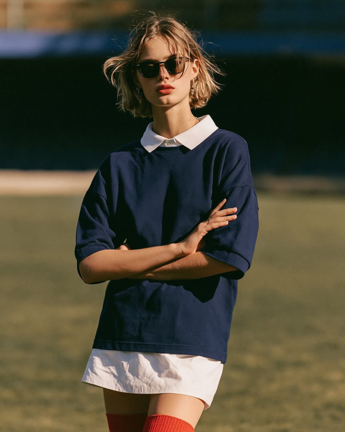 Moody sports fashion editorial portrait, stylish young woman standing c… 2