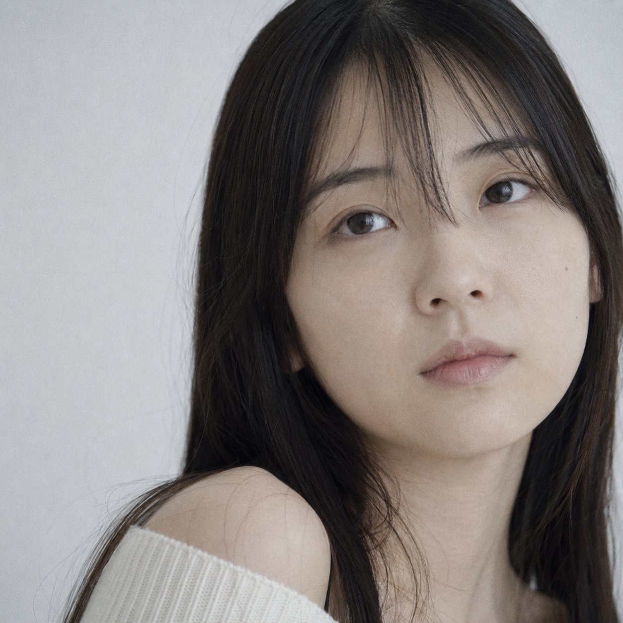 Portrait shot on 85mm f/1.8, tight close-up face portrait of a Japanese…