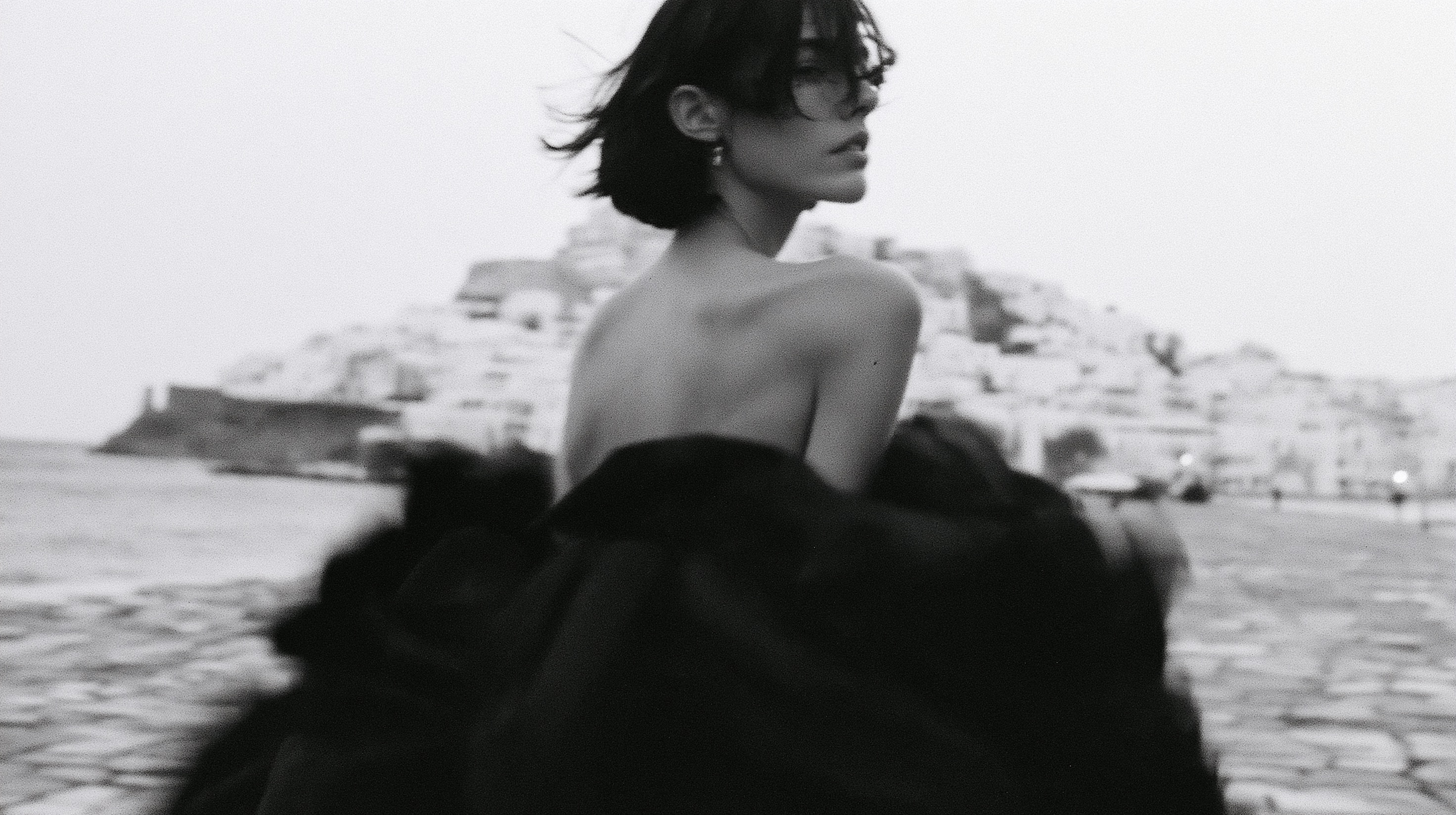 High-fashion black and white photo. A young woman with a short dark bob…