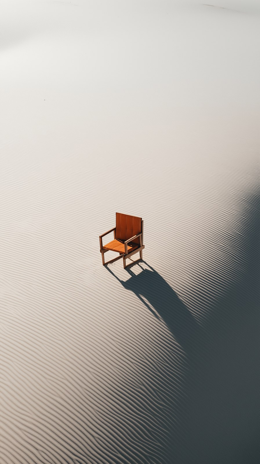 a chair in the middle of an empty desert in an aerial shot --chaos 20 -…