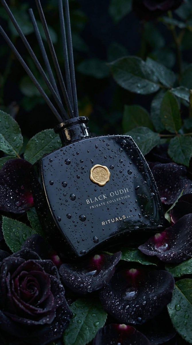 Ultra-realistic luxury product photography of a black glass reed diffus…