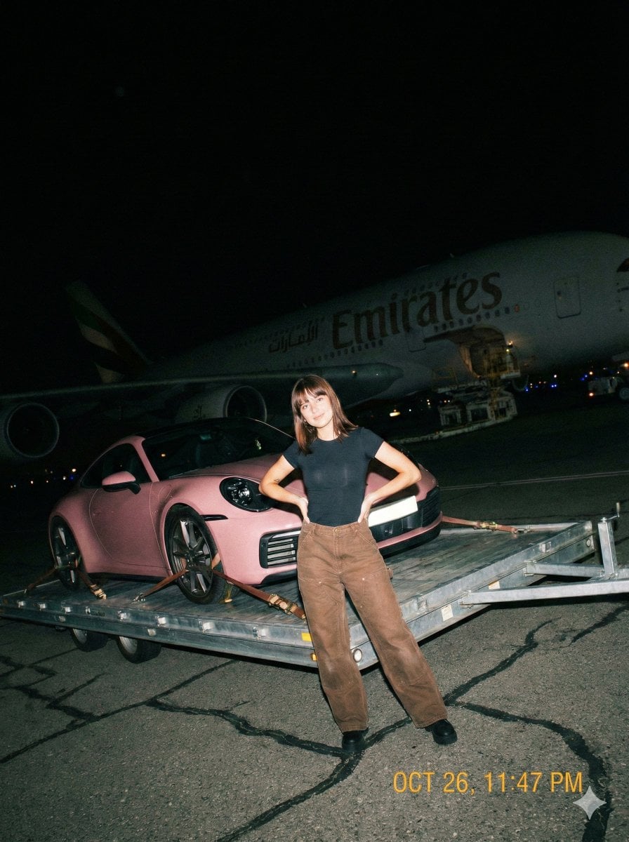 A gritty, handheld iPhone photo taken at night on an airport tarmac wit…