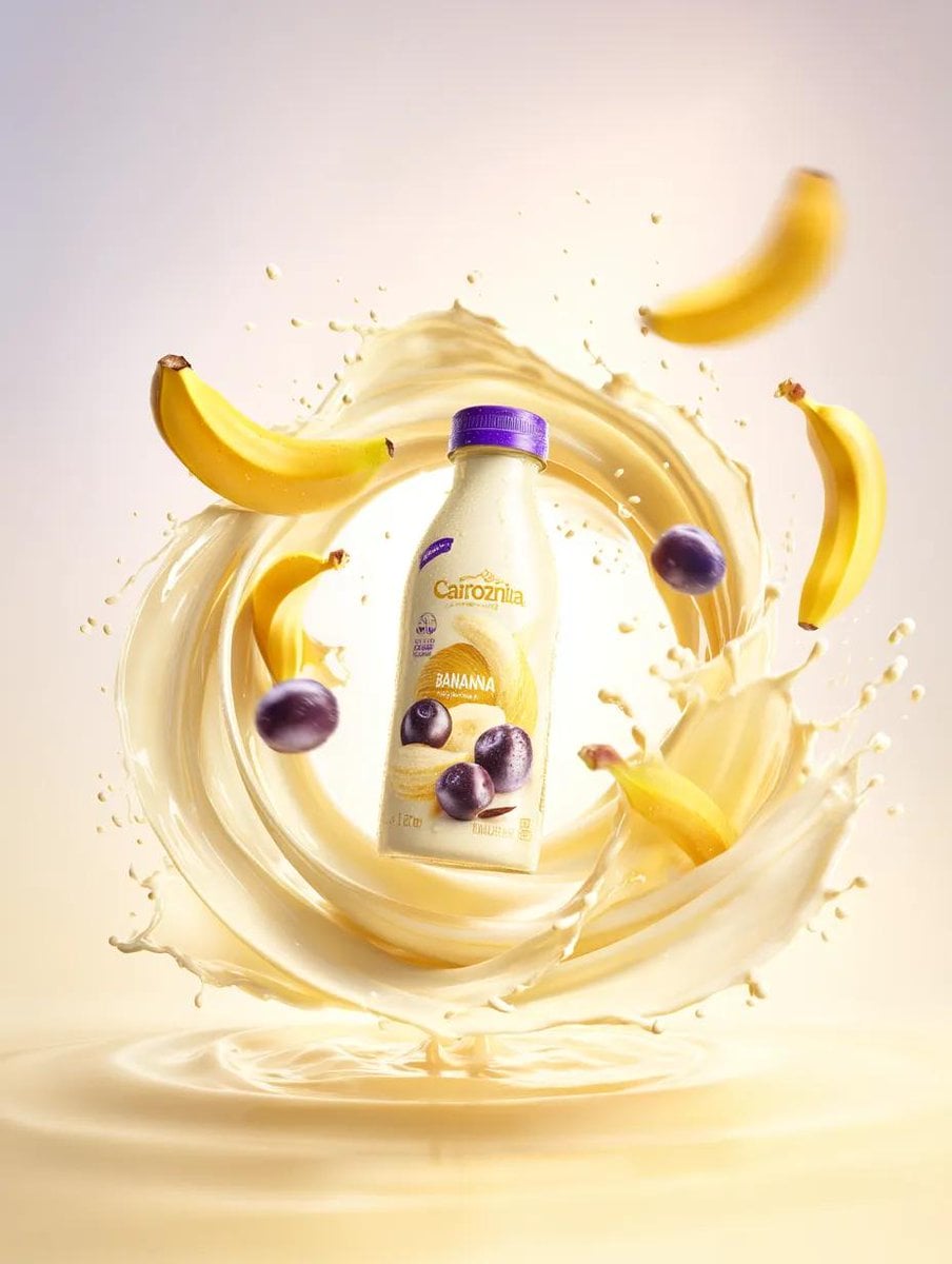 Premium banana milk drink bottle surrounded by swirling milk splash, fl…
