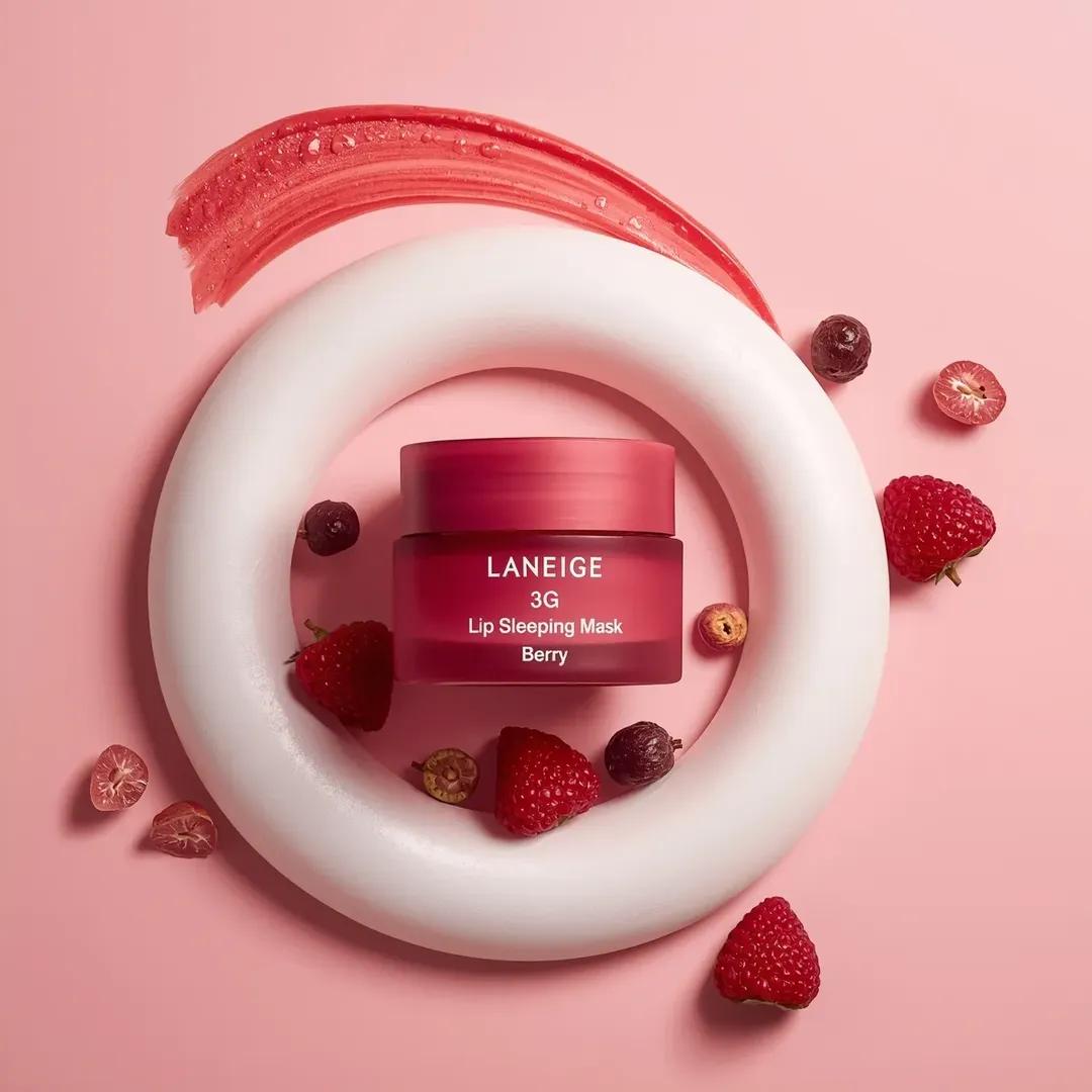 A centrally placed pink cosmetic jar labeled “LANEIGE Lip Sleeping Mask…